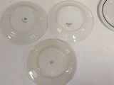many plates that are sitting on a white table