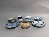 many different bowls and cups sitting on a table