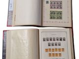 two pages of a book with stamps are open on a white background