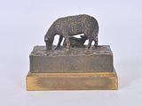 a statue of a sheep and a dog on a table