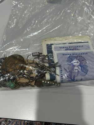 a lot of coins and other items in a plastic bag