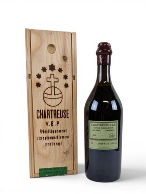 a bottle of wine sitting next to a wooden box