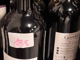 several bottles of wine are lined up on a shelf in a store
