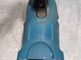 a blue electric driller on a white surface