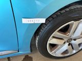 a blue car with a sticker on the side of it