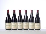 six bottles of red wine lined up in a row