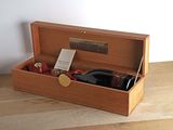 a bottle of wine in a wooden box on a table