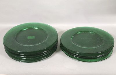 two green plates sitting on a white surface