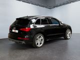 the rear end of a black audi suv parked in a showroom