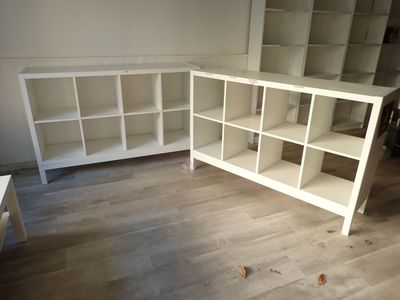 a white bookcase and a white desk in a room