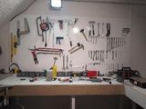 a workbench with many tools on it in a garage