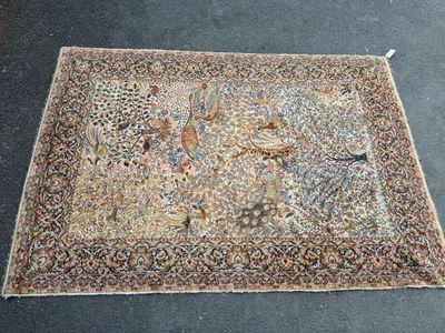 an oriental rug with birds and flowers on a black ground