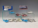 a lot of toy cars that are on a glass shelf