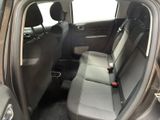 the back seats of a car with a bottle of wine in it
