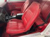 a red leather seat in the back of a red car
