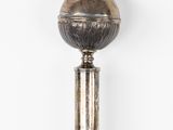 an image of a silver ball on top of a wooden pole