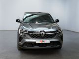 the front view of a grey car in a white room