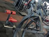 a gym with a row of exercise equipment in it