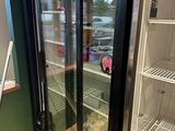 an image of a refrigerator in a store with its doors open