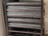 a stack of metal plates on a cart in a room