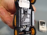 a person holding a small toy car in their hand
