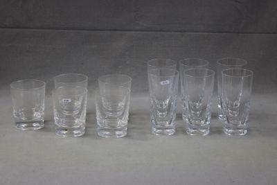 six shot glasses lined up in a row on a table