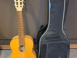two guitars are sitting next to each other on the floor