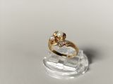 a close up of a gold ring with a pearl and a diamond