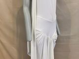 the mannequin is wearing a white dress with a long skirt