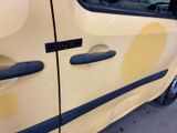 a yellow car with a blue stripe on the side of it