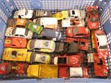 a basket full of toy cars and trucks in it