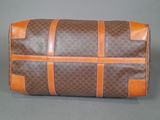 a close up of a brown and brown bag on a gray surface