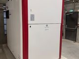 a white refrigerator with red trims in a building