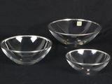 three clear glass bowls sitting on top of a black surface