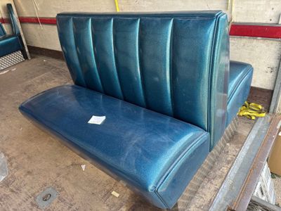 a blue bench that is sitting in a room