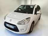 a small white car parked in a white room