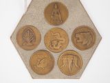 a plaque with four different types of coins on it