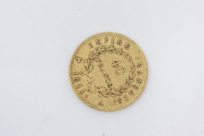 a gold coin with a wreath on the front of it