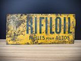 an old yellow sign sitting on top of a wooden table