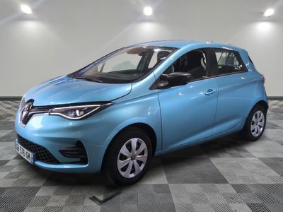 a blue car is parked in a room with a checkered floor
