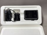 a white box with a charger and a cell phone in it