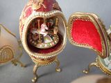 a small egg with a carousel in it sitting on a table