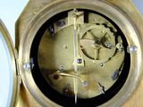 a gold clock that is sitting on a table