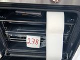 a roll of toilet paper taped to the inside of an oven