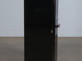 an image of a black refrigerator in a room