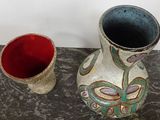 two vases that are sitting next to each other on a table