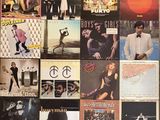 a lot of album covers on the wall of a room