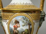 a white and gold vase with a painting on it