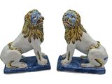 pair of blue and white lion figurines on blue base