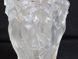 a glass vase with a design on it on a black background